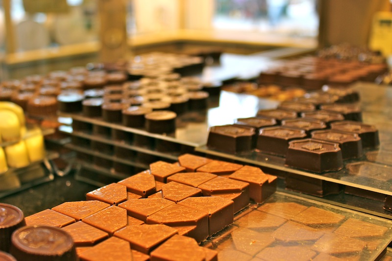 Discover how centuries of global trade shaped local chocolatiers. Uncover the rich history of Belgian chocolate and taste the finest creations on a food tour.